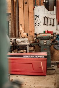 tool box inside of what seems to be a tool shed between tons of tools used ny workes of all kinds
